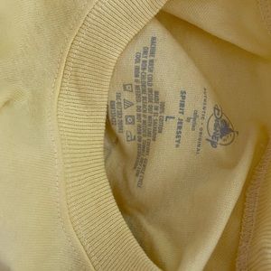 Yellow Walt Disney World Spirit Jersey. New with tag. Size Large. Runs big.
